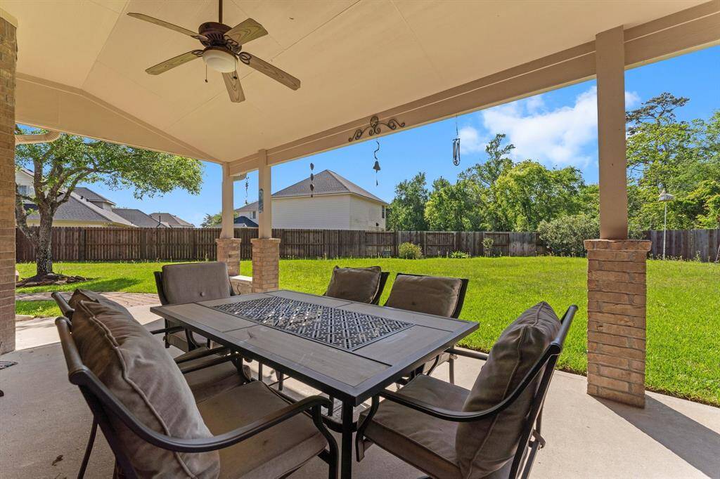 Step outside to your serene backyard, featuring a massive covered patio with dual ceiling fans, ideal for enjoying Houston’s beautiful weather year-round.