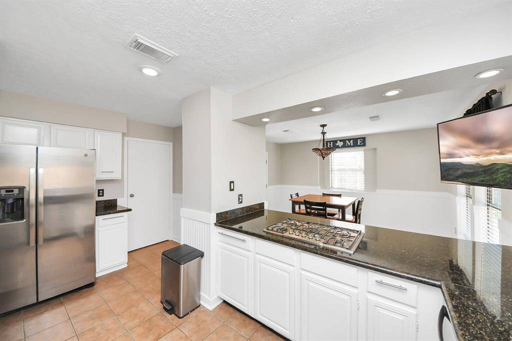 The kitchen layout helps streamline the cooking process making entertaining effortless and enjoyable. Recessed lights provide additional lighting if needed.