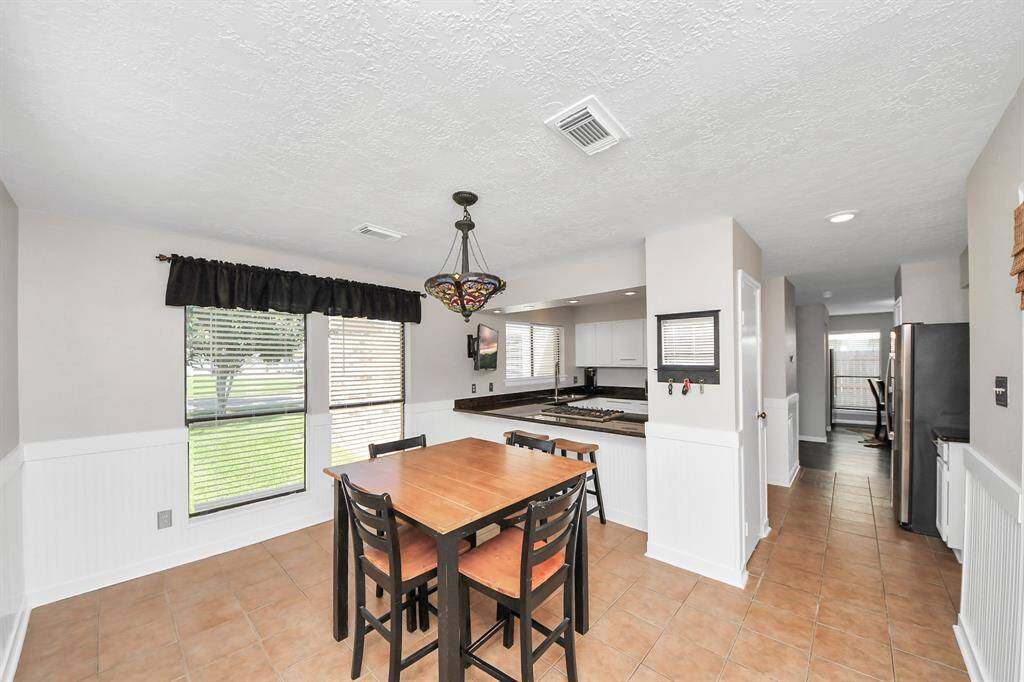 The breakfast area is generously sized, making it perfect for enjoying quick meals or casual snacks throughout the day. For added convenience, the extended granite countertop offers additional seating with space for counter stools.