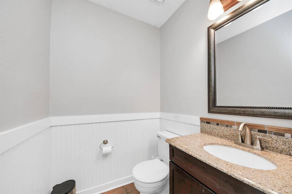 A powder bath downstairs adds both style  and practicality, serving as a necessary and convenient amenity for guests.