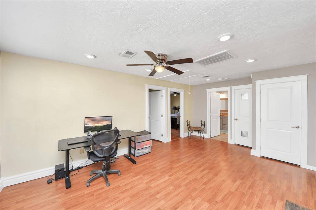 The upstairs game room, featuring durable wood laminate floors, offers endless possibilities and can serve a multitude of purposes—whether it is a playroom, home theater, or a versatile space for hobbies and entertainment.