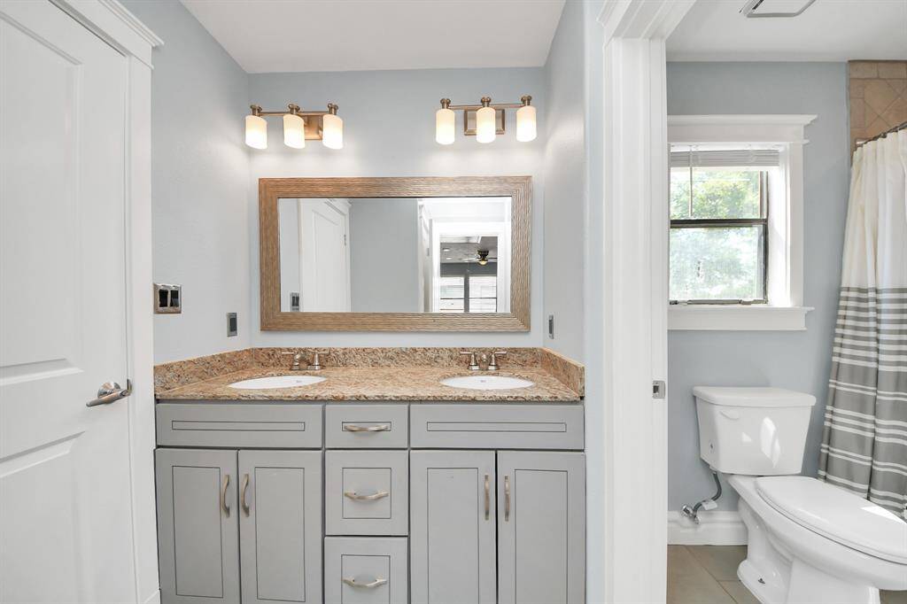 The remodeled bathroom upstairs is conveniently situated between both bedrooms, offering easy access for each bedroom. With a thoughtful design, it serves as a space that enhances the comfort of the entire upper level.