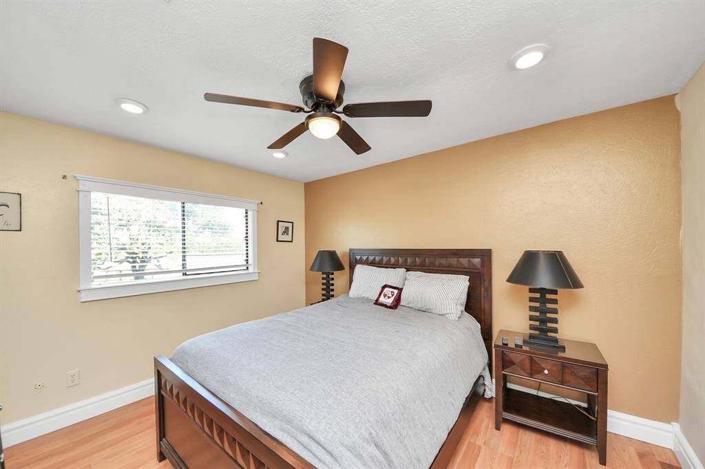 The other secondary bedroom upstairs are both generously sized, featuring wood laminate floors and walk-in closets. These rooms provide ample space and storage.