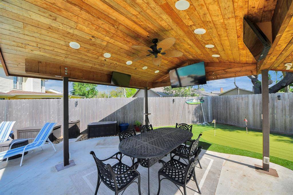 The ceiling of the pergola is finished with beautiful wood, enhancing the overall warmth and elegance of the outdoor space.