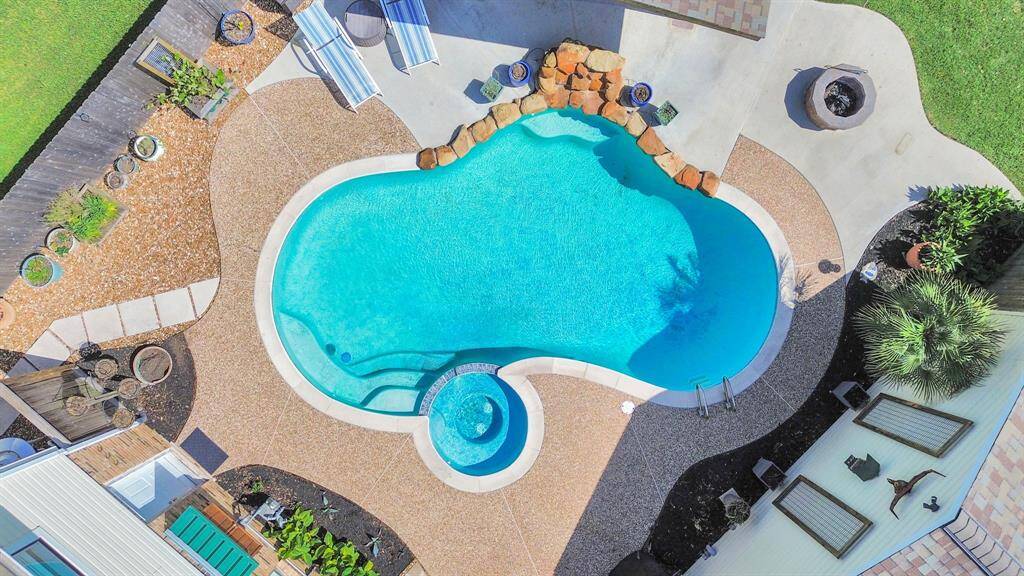 This aerial perspective captures the true scale of the pool and spa. This home offers a rare sense of seclusion.