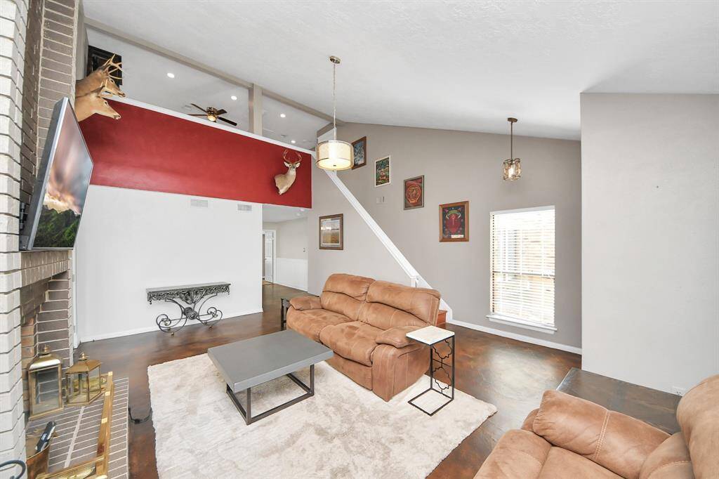 Soft gray tones, bright white trim, and a striking chandelier give the space a refined yet inviting feel.