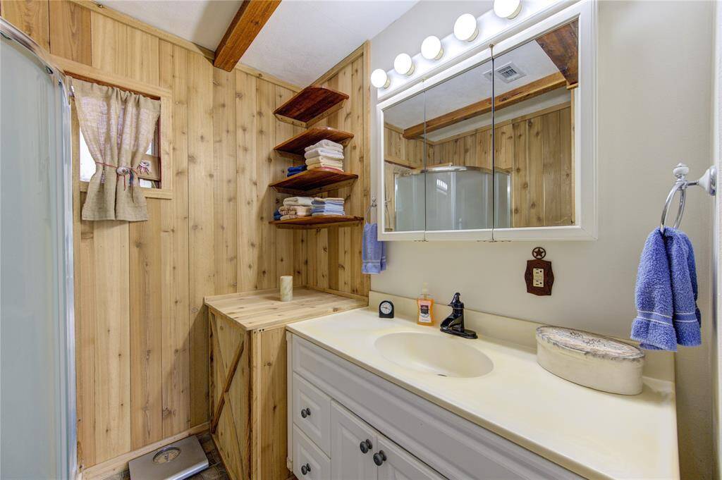 Primary bathroom with shower and plenty of space for storage.