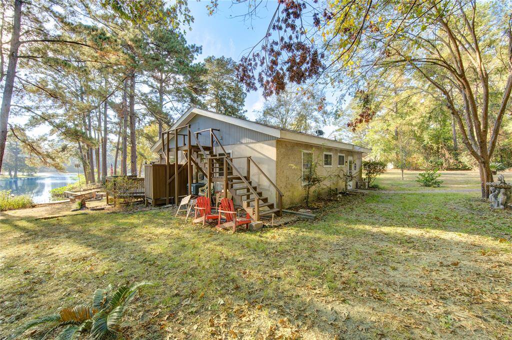 Back view of the home with stairs to a full attic for plenty of storage.