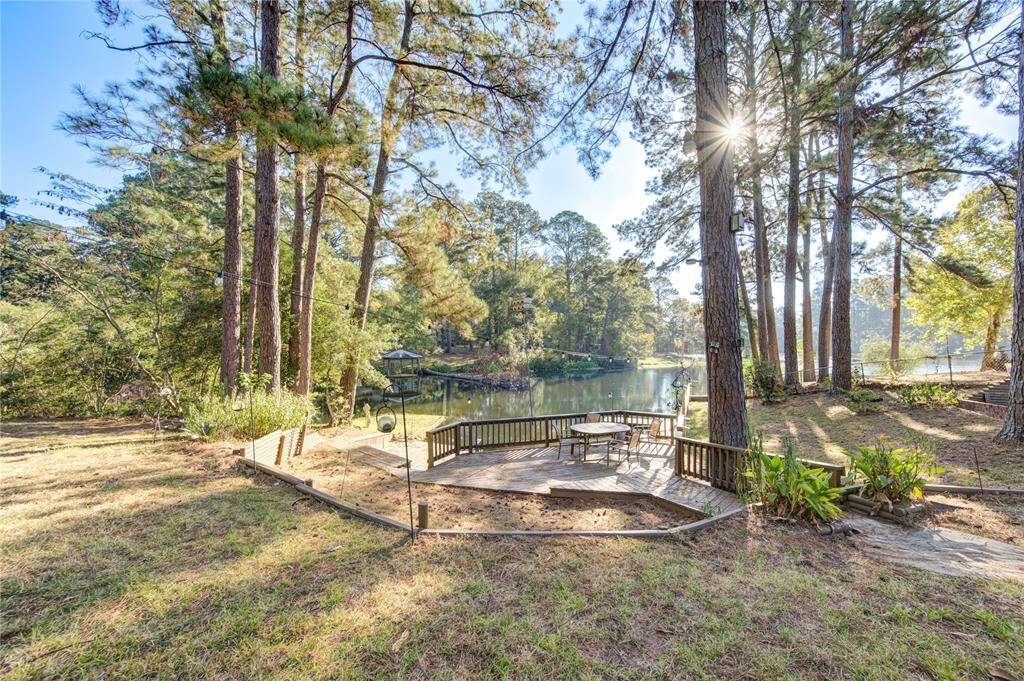 Scenic deck view overlooking serene waterfront and lush pines.