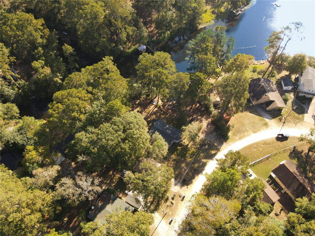 Captivating bird's-eye view showcasing the lush surroundings and proximity to the water.