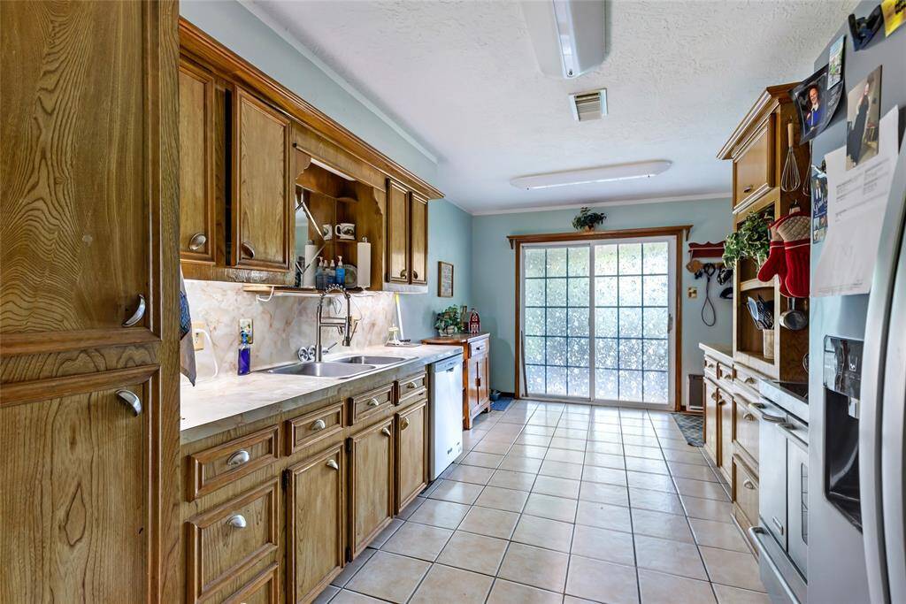 This photo showcases a cozy dining area. It opens into a kitchen and a glimpse of a living room, offering an open and connected layout. The space is well-lit with natural light.