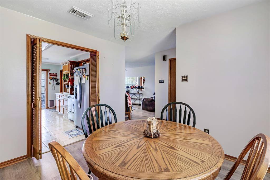 This spacious primary bedroom features easy maintenance flooring and ceiling fan.  A large window adds natural light.