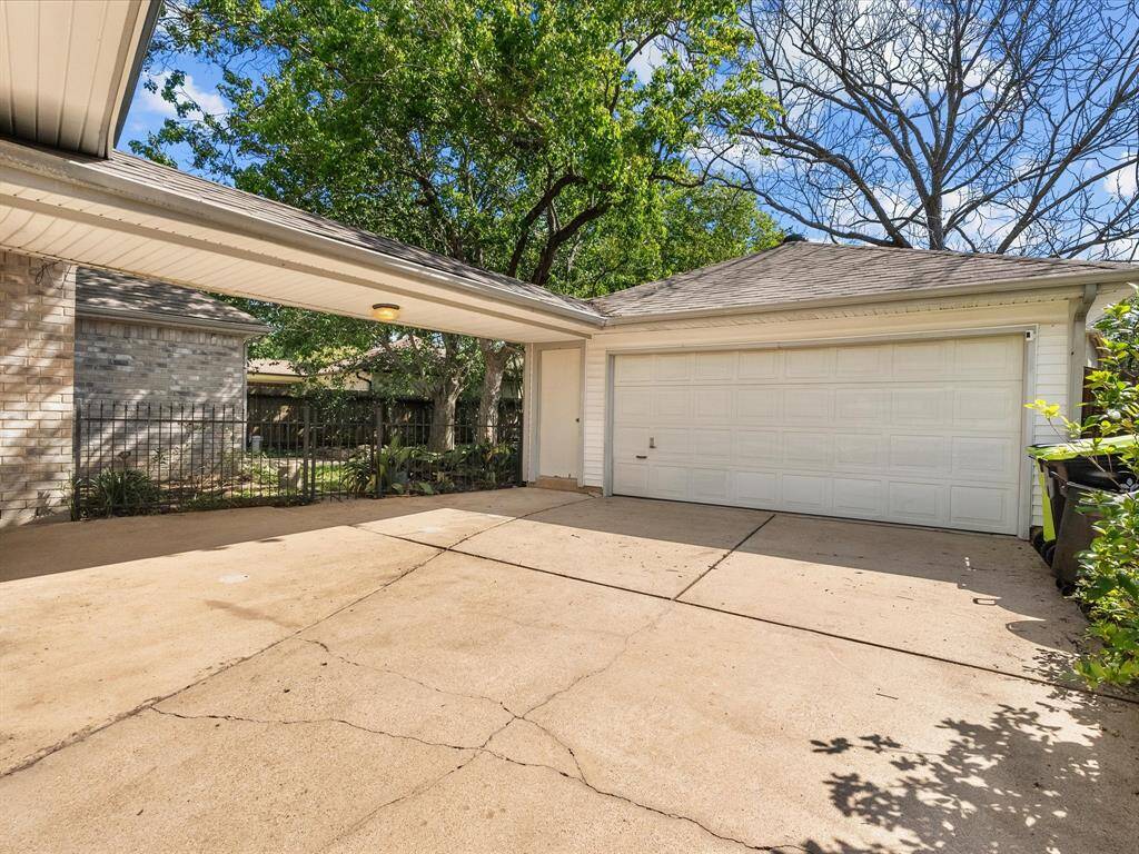 Spacious detached 2-car garage with extended driveway—ideal for extra parking or a game of hoops.