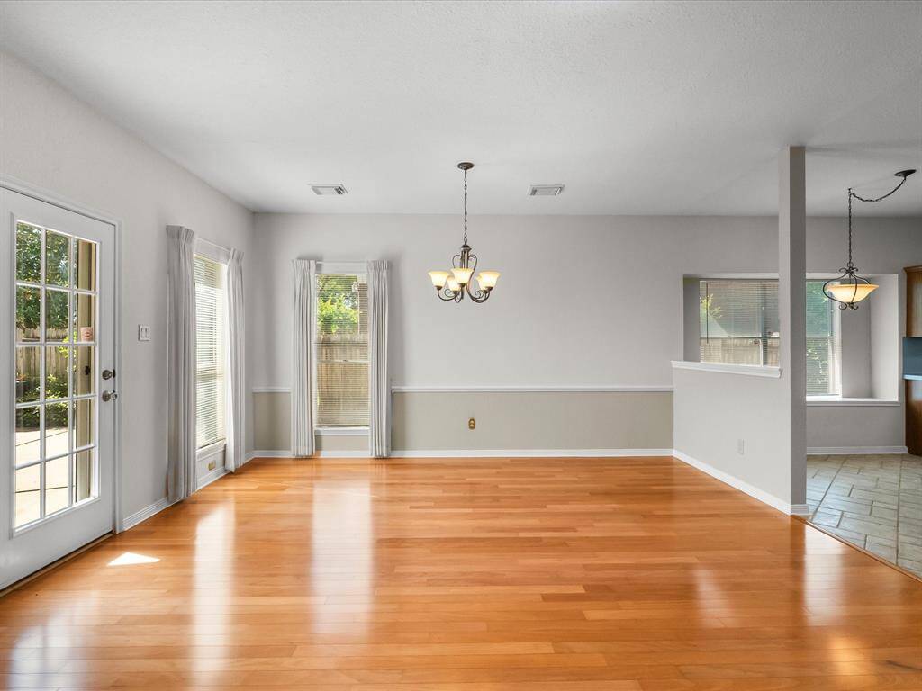 Bright dining space with backyard views and access through French doors.