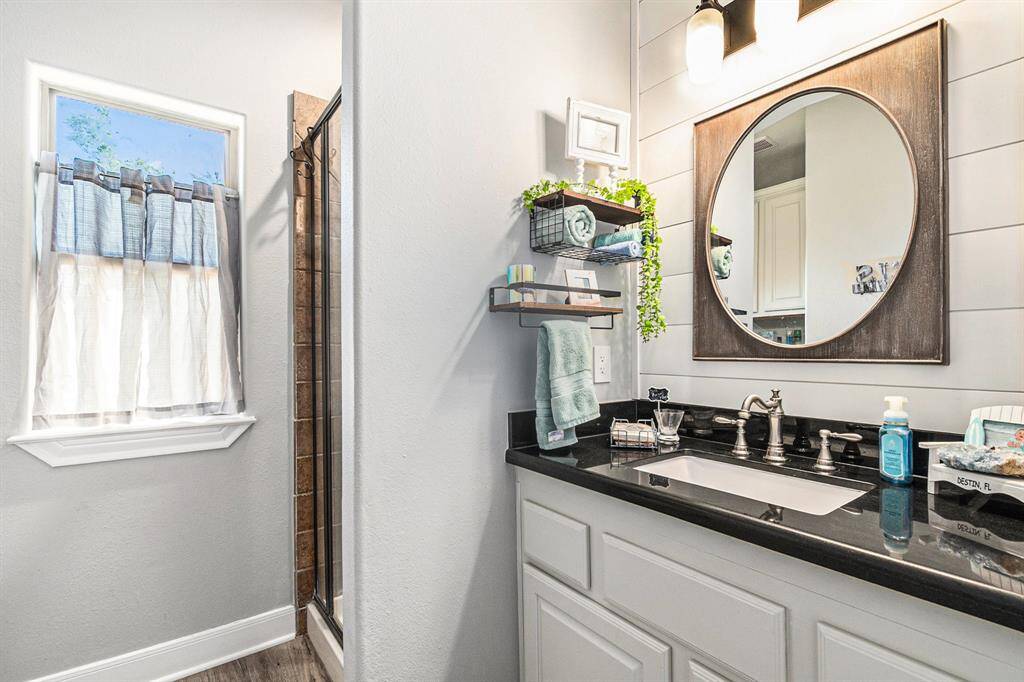 Full bath near laundry room and back separate bedroom