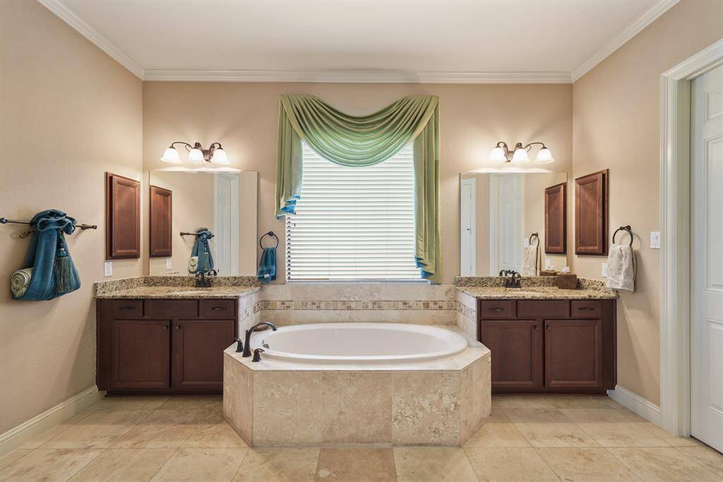 Another view of a luxurious central bathtub with elegant tile surround.