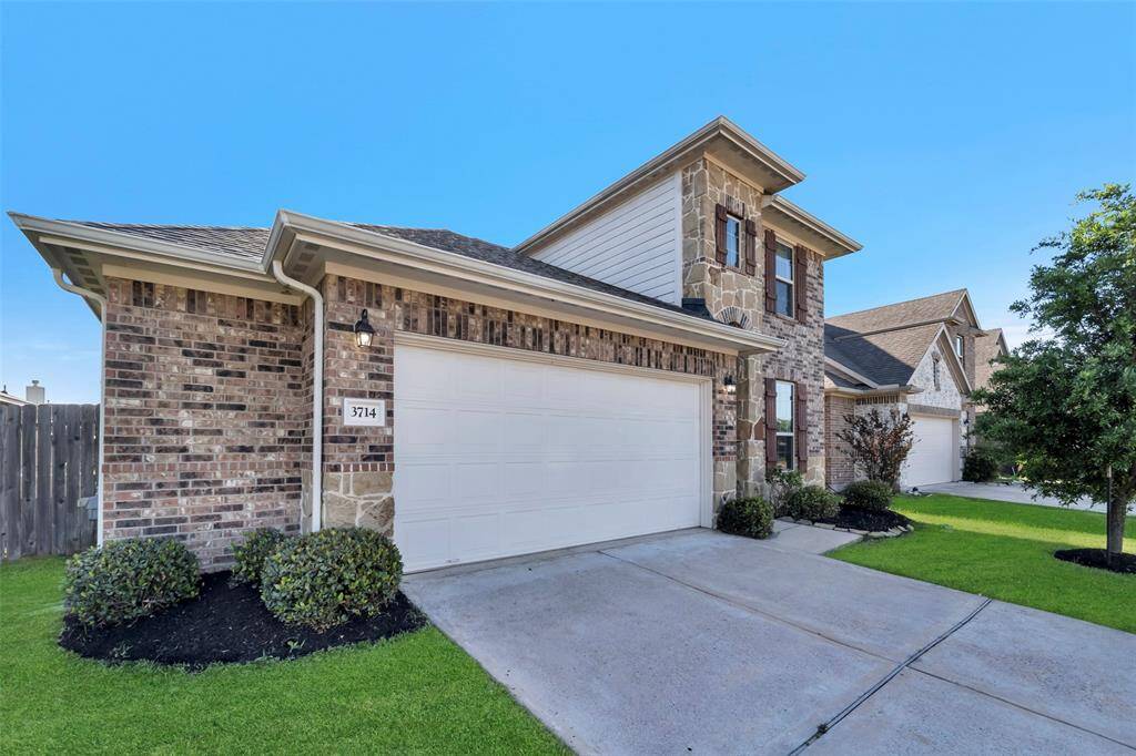 Charming two-story home with a brick and stone exterior, featuring a spacious two-car garage and a well-maintained front yard. Ideal for families seeking a welcoming neighborhood.