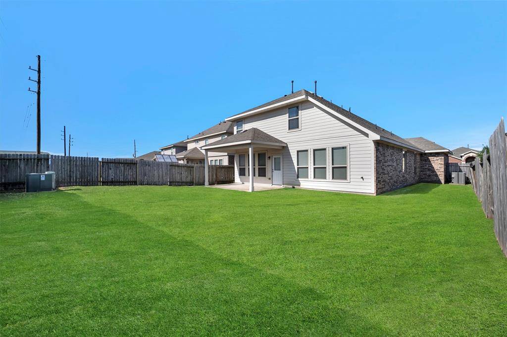 Spacious backyard with a view of the home's inviting exterior.