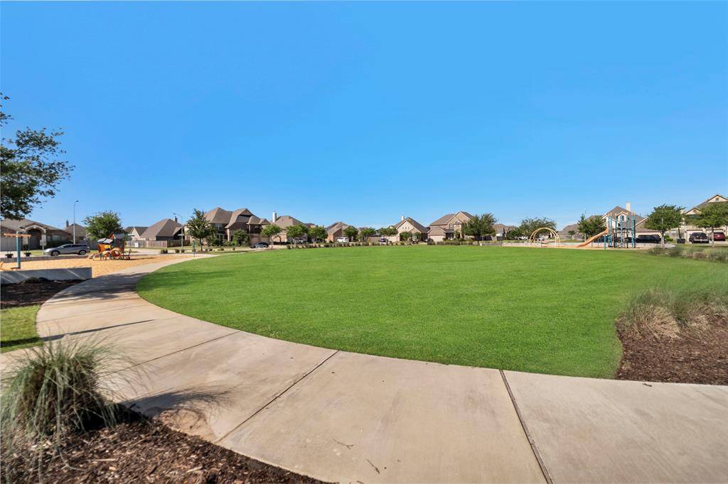 Charming neighborhood park with lush green spaces and a playground, perfect for relaxation and family fun.