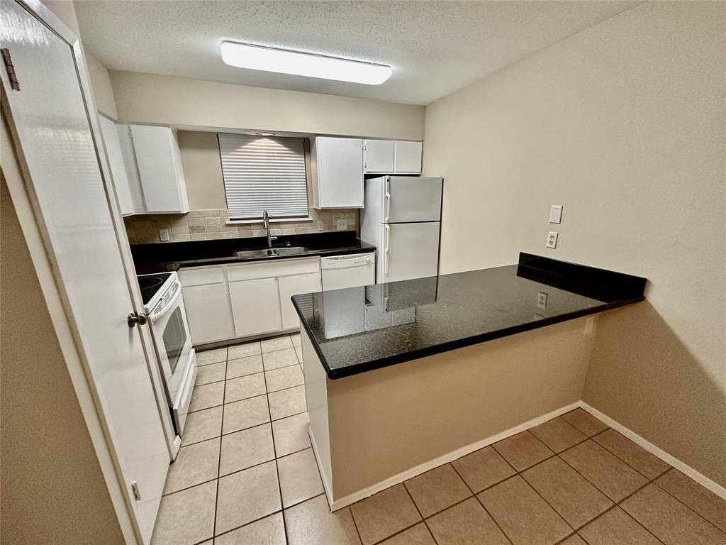 Unit 139 features Granite countertops, tile and wood flooring, fresh interior paint, newer appliances