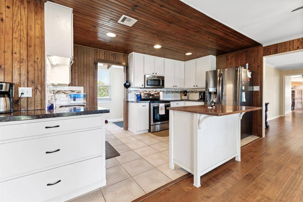 Galley style kitchen with original to house Knotty pine ceilings and walls