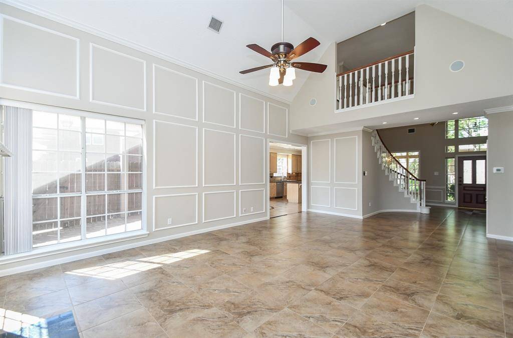 Experience the expansive elegance of this airy, two-story family room.