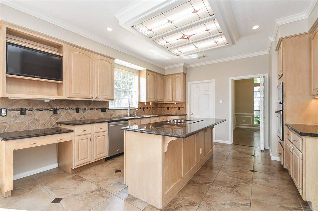 Abundant cabinetry offers ample storage in this spacious kitchen.