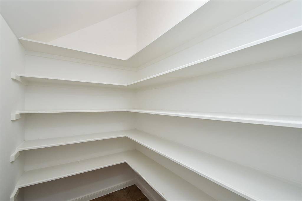 Spacious walk-in pantry for all your storage needs.