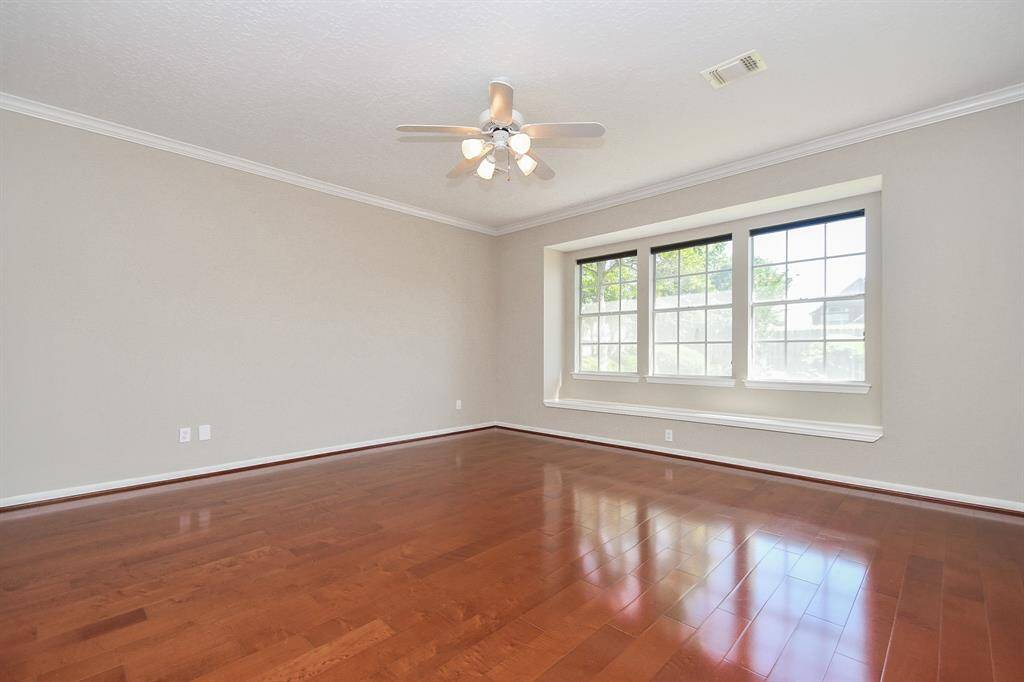 The primary bedroom, conveniently located on the first floor, offers serene backyard views.