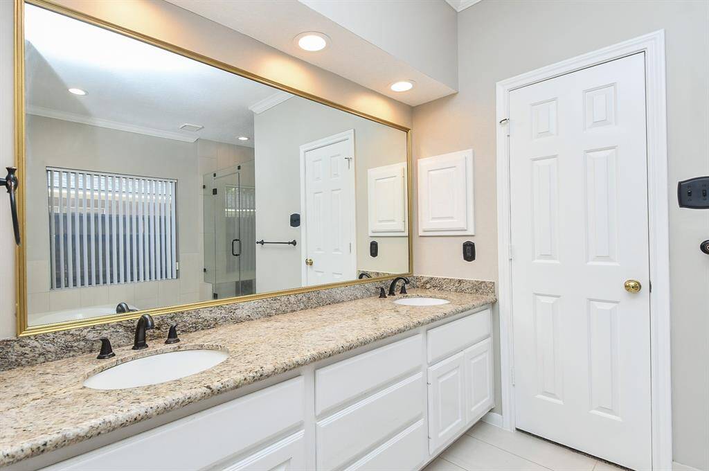 Experience luxury with dual sinks in the beautifully updated primary bathroom.