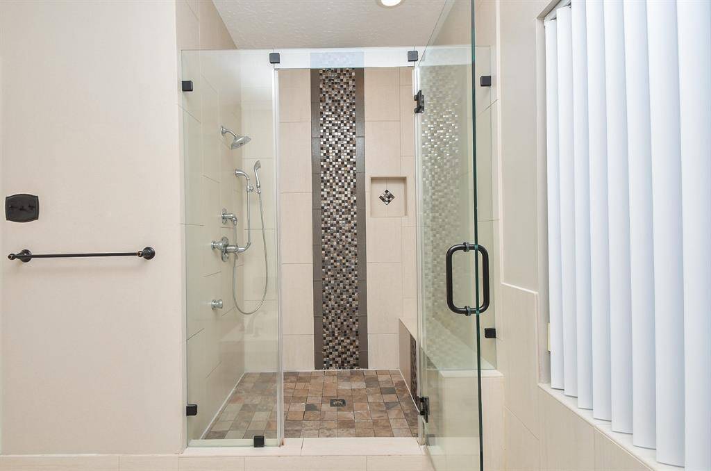 Luxurious, spacious walk-in shower with modern updates.