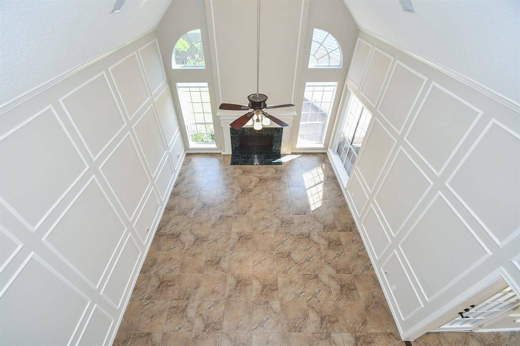 Experience the spacious first-floor family room from the elegant second-floor catwalk.