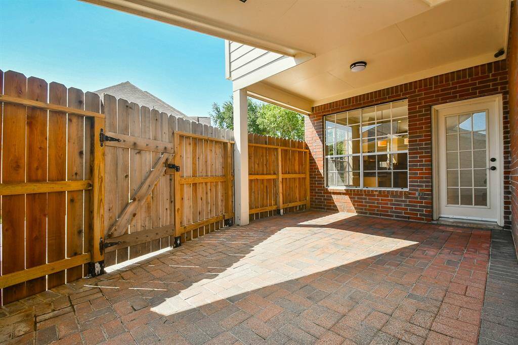 Enjoy seamless indoor-outdoor living with a charming covered back porch and a convenient walkway connecting the house to the garage.