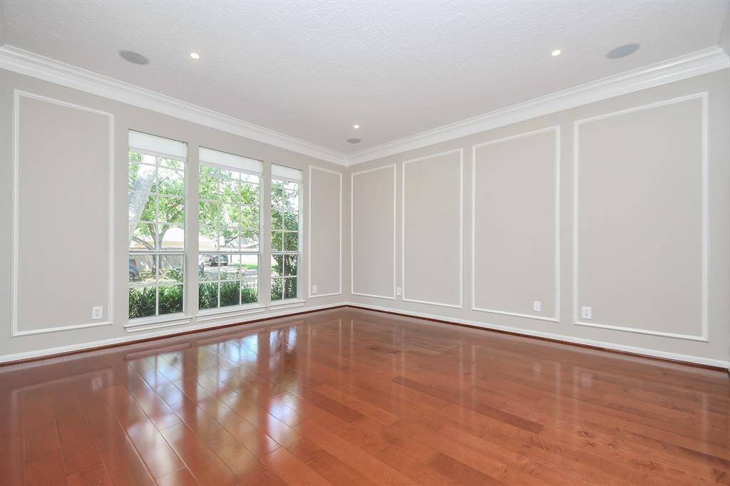Expansive study with elegant wood floors, perfectly positioned at the front of the house.