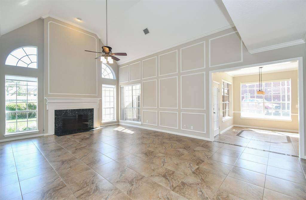 Spacious two-story family room with elegant fireplace.