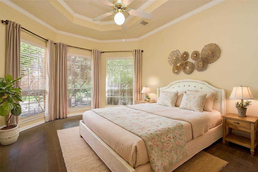 Primary bedroom beautiful flooring, crown molding and lots of natural light *virtually staged*