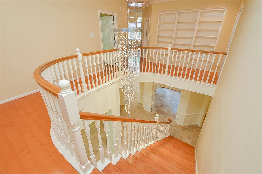 Beautiful shot of the ELEGANT chandelier! Plus floor to ceiling built in bookshelves