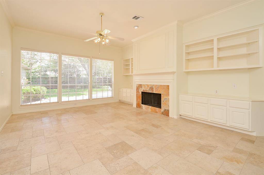 Family room w/out virtual staging- SPACIOUS, beautiful flooring and eye catching fireplace