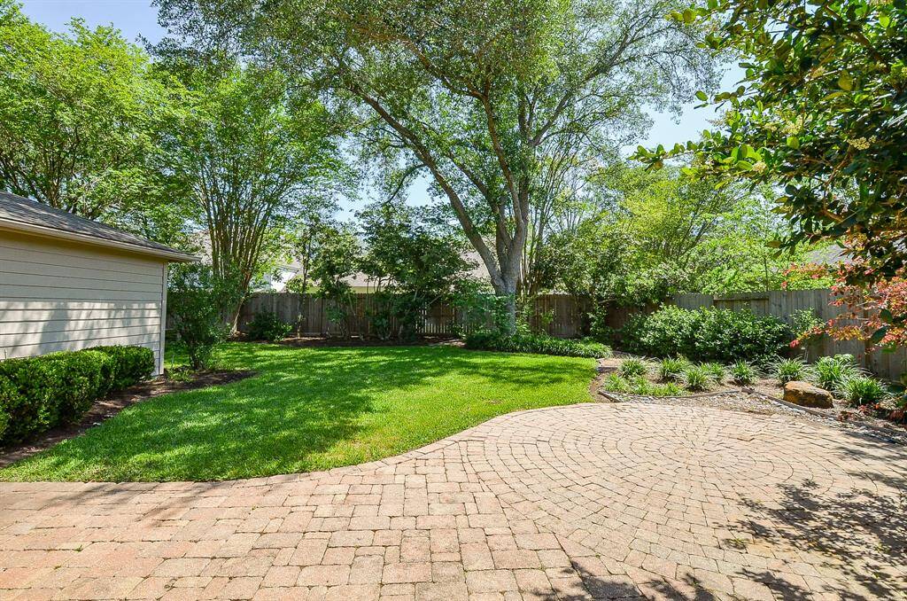 Another view of the patio, lawn and there is space behind the garage too!