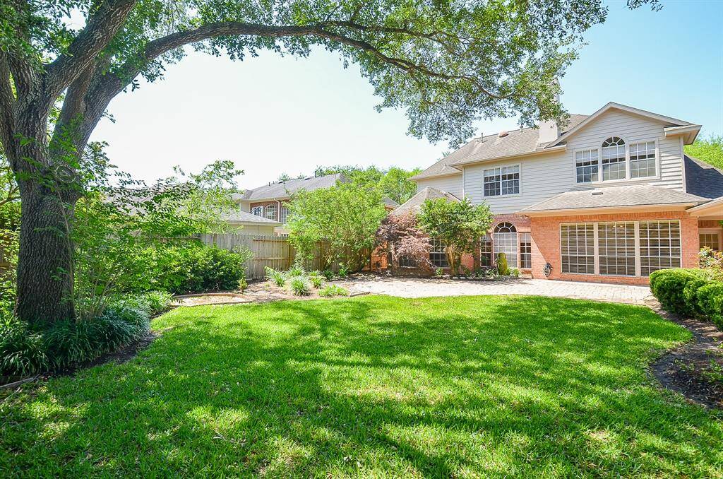 Look at all of this shaded green space! A wonderful backyard!