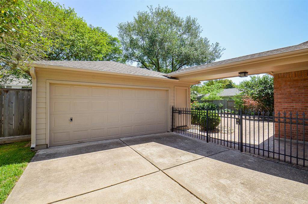 Two car detached garage, wrought iron fence and gate leads to the private backyard space