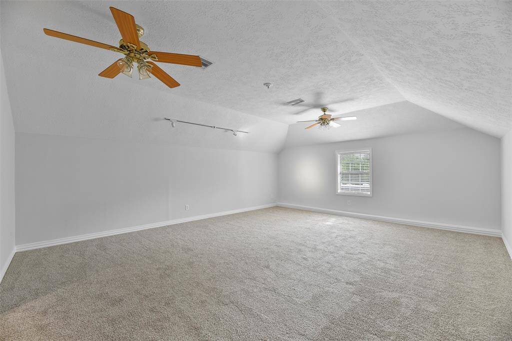 The second floor hosts a massive 21'x18' game room with a gambrel ceiling, a pair of lighted ceiling fans, track lighting, fresh neutral paint, plush new carpet, and a window with 2-inch blinds. This space is perfect for a media room, a pool table, a craft space - whatever suits your needs!