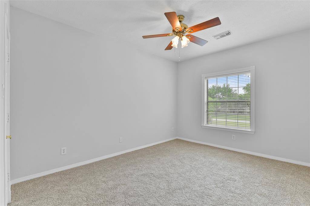 On the second floor, you'll find two additional secondary bedrooms, each featuring a lighted ceiling fan, fresh neutral paint, brand-new plush carpet, a walk-in closet, and a cased window dressed with 2-inch blinds.