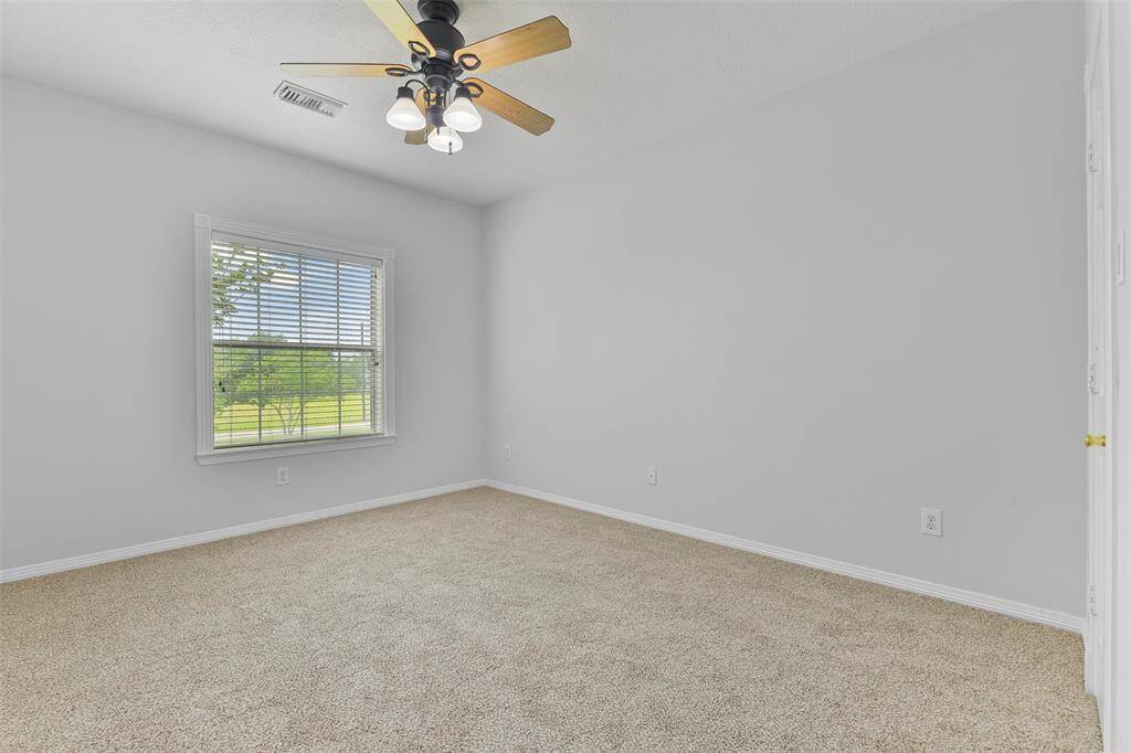 On the second floor, you'll find two additional secondary bedrooms, each featuring a lighted ceiling fan, fresh neutral paint, brand-new plush carpet, a walk-in closet, and a cased window dressed with 2-inch blinds.