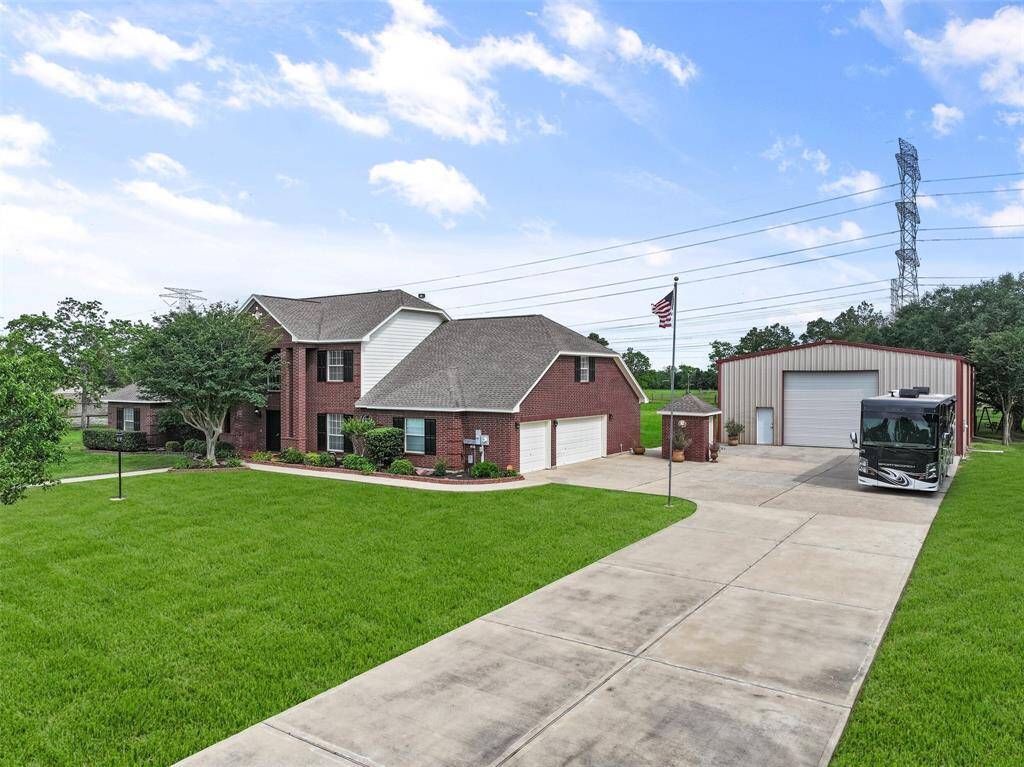 You'll enjoy an abundance of parking space with a double wide driveway, an ample parking pad, a three-car attached garage, plus an impressive 40'x60' metal outbuilding with front & back bay doors, a 3500 psi foundation, and a 200 amp breaker. Bring your RV!