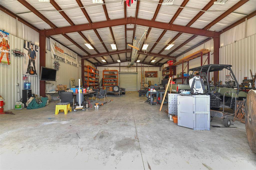 Run a business, enjoy a hobby, or store your toys in this 40'x60' metal workshop with three bay doors, a 20 amp breaker box on its own separate meter, and an extra sturdy 5-inch thick 3500 psi foundation. The possibilities are endless!