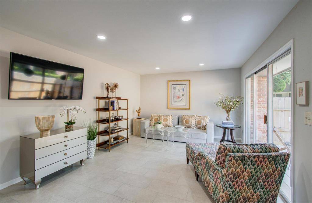Sliding doors to the deck on right.  Durable, easy-care porcelain tiles and adjustable, recessed lighting throughout this beauty.