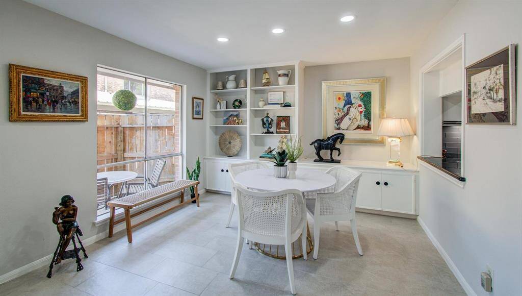 The spacious dining space offers built in display space and over 10 feet of closed storage.  Recessed lighting means you can furnish in any number of ways; this could also serve as a home office space with a great view!