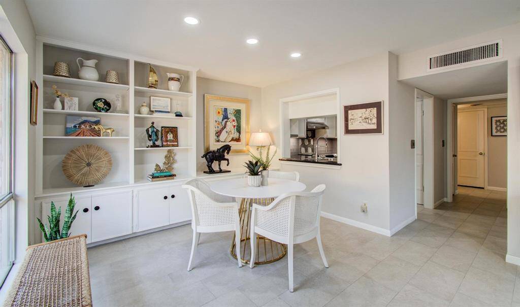 View from entry towards dining space.  Space easily could seat 6-8 people.  Door visible at end of hallway is the laundry room.