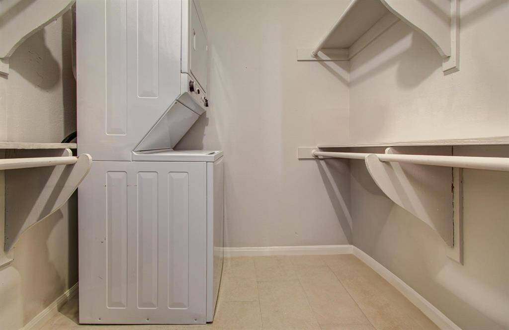 This full-sized laundry room with included stackable washer and dryer has a whopping 18 feet of both hanging and shelf space!